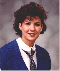 Color photograph of Jolynne in a blue sweater and a white shirt